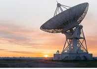 A radio telescope dish at sunset